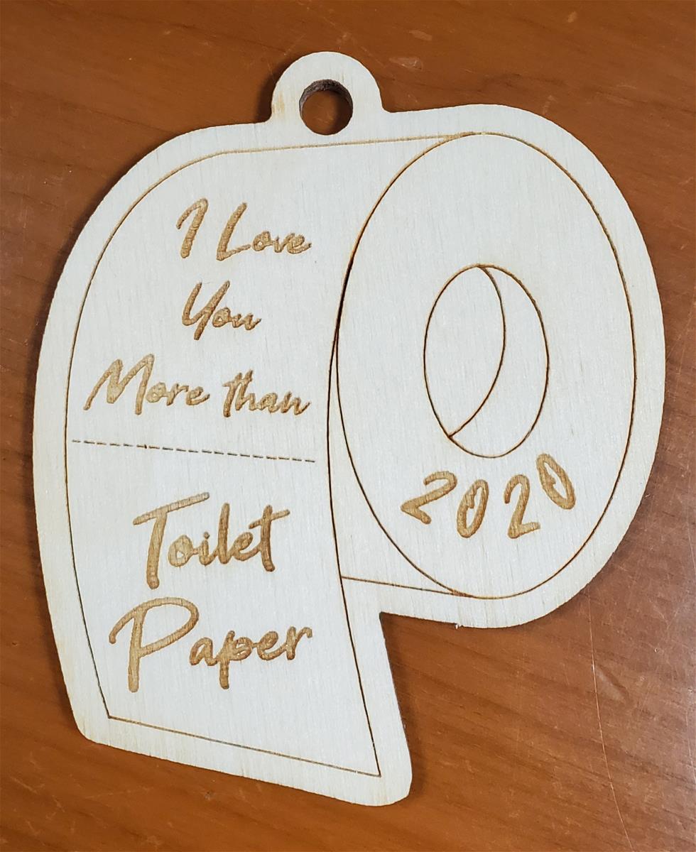 Wooden Wooden cut-out in the shape of a roll of toilet paper; contains text