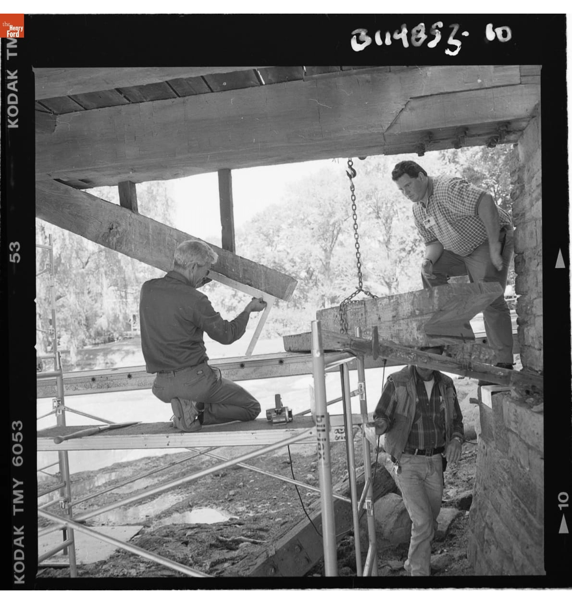 GIF slowly cycling through three black-and-white images of construction work on a wooden structure