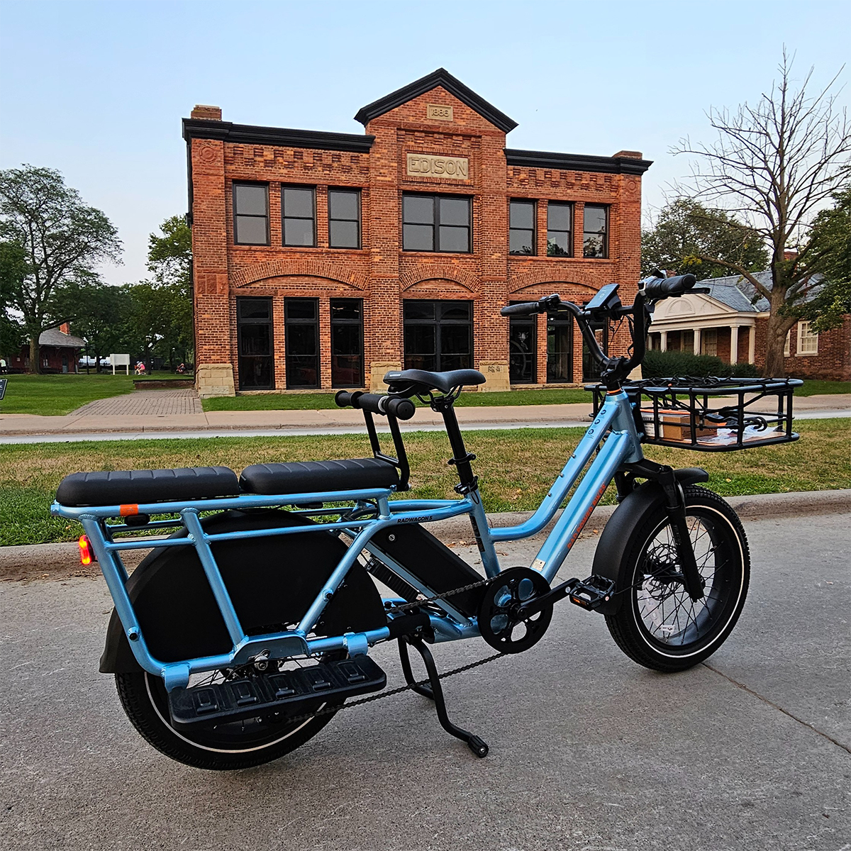 a blue bicycle in front of a brick building