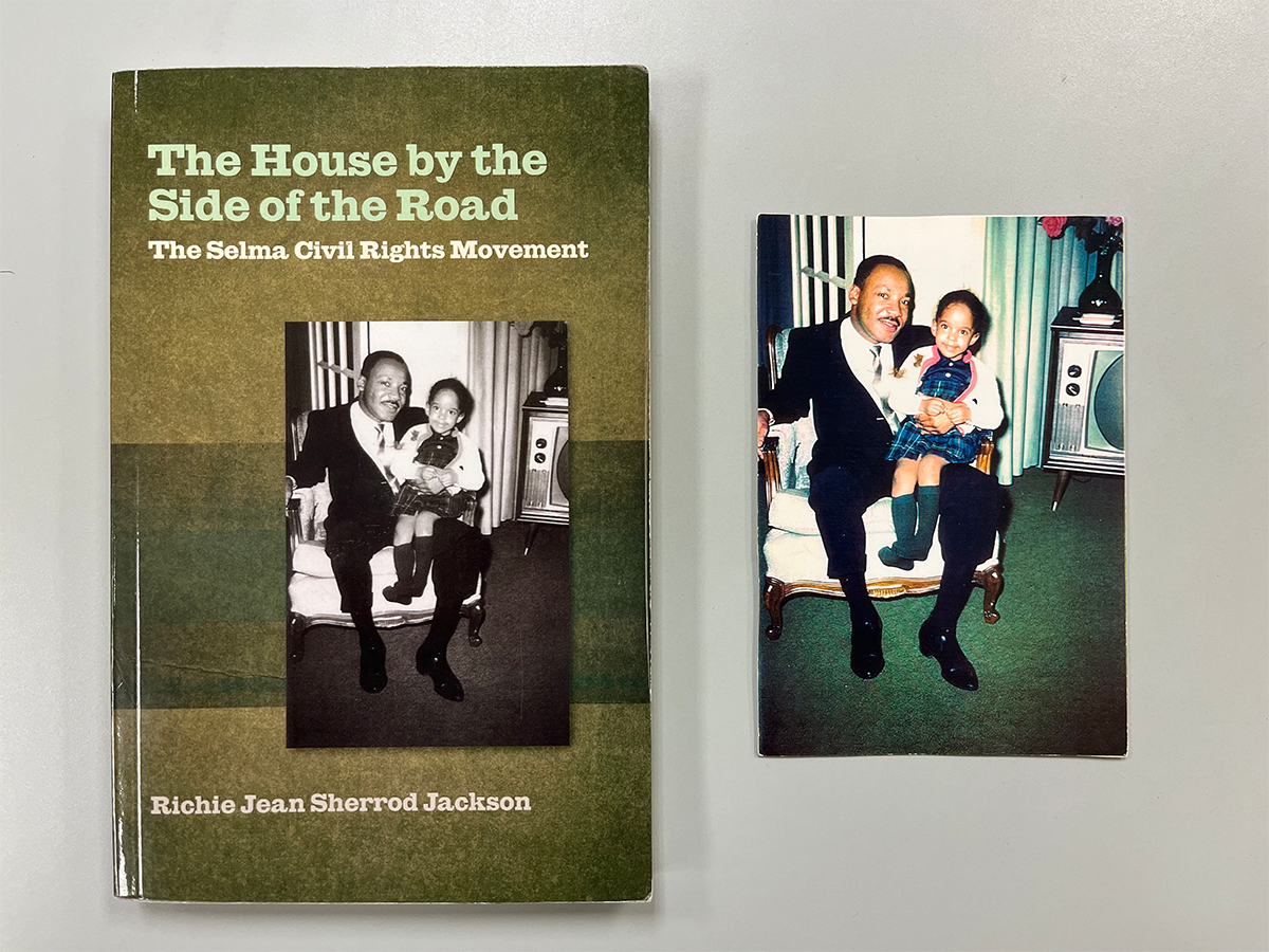 The 2015 paperback edition of The House by the Side of the Road alongside the 1965 image featured on its cover of Jawana Jackson and Dr. Martin Luther King Jr.