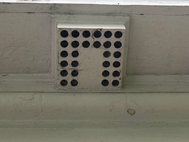 Mutule on the Webster House Architectural element of white box with round holes in a