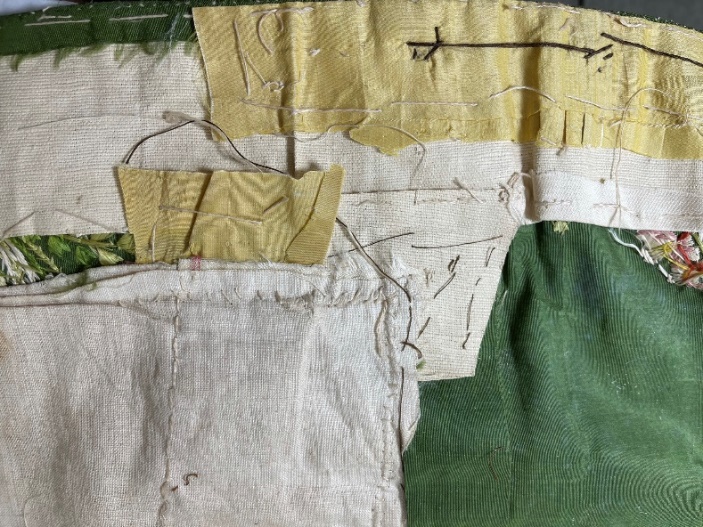 Numerous patches in various fabrics, layered messily upon each other