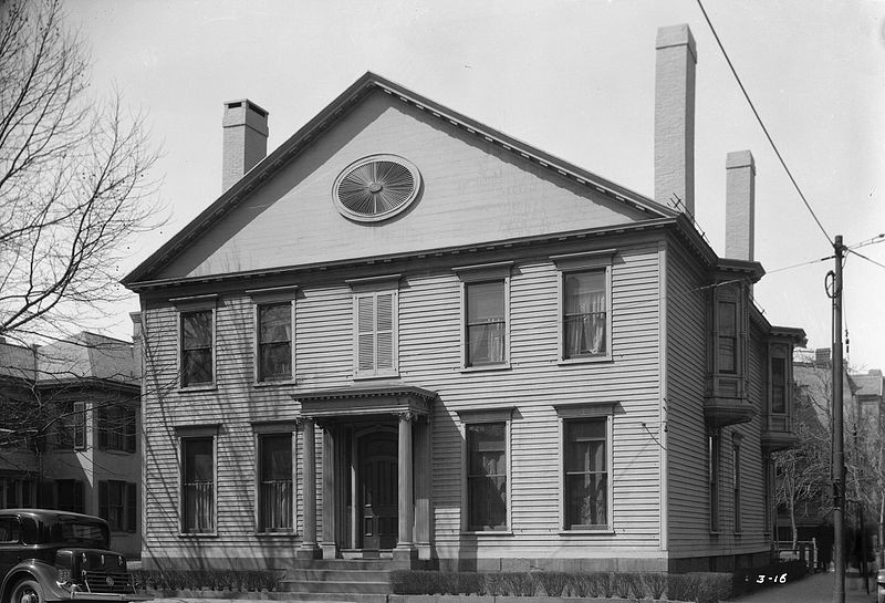 Exterior of the Noah Webster House at its Original Site, New Haven, Connecticut, March 31, 1934 Black-and-white photo of two-story wooden house with columns flanking front door