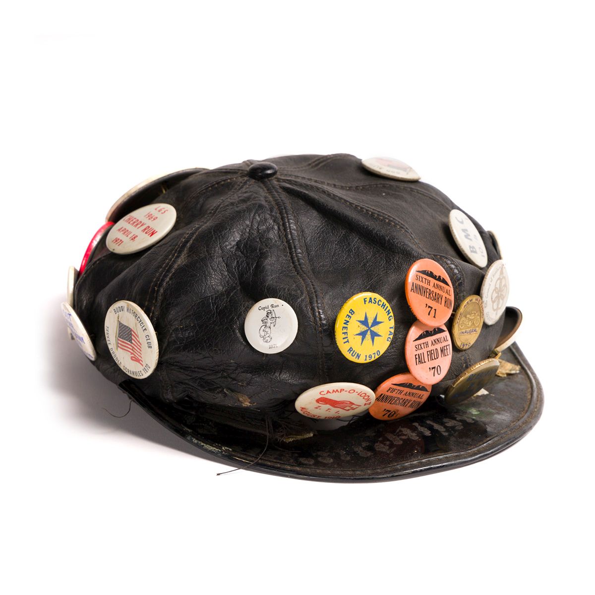 Black leather cap covered in buttons with images and text