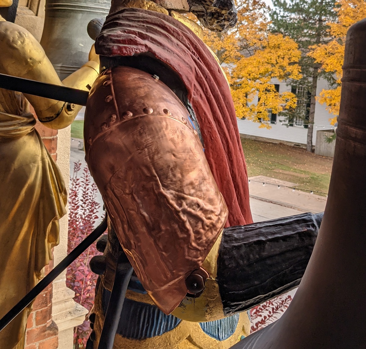 Statuary figure from the side, showing copperplated arm