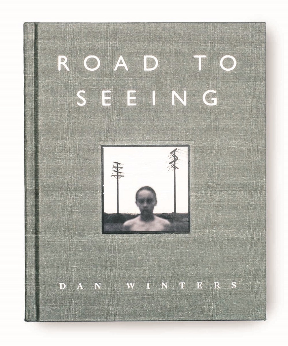 Road to Seeing by Dan Winters Gray book cover with white text and photo of person's head and torso in landscape