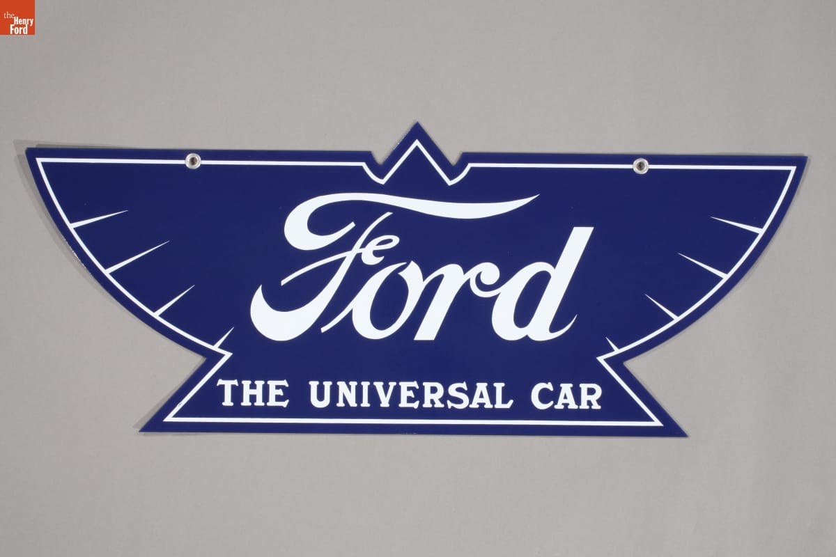 Blue sign in the shape of a stylized eagle with white text 
