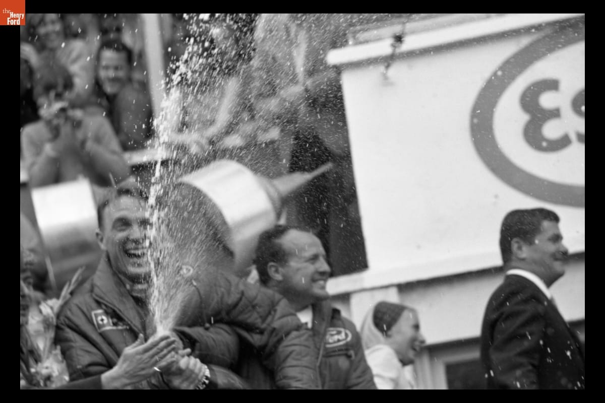 Gurney spraying champagne after victory.