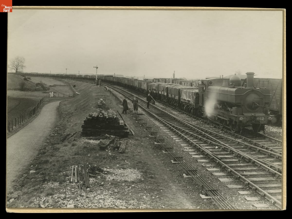 Train with many open cars packed with pallets