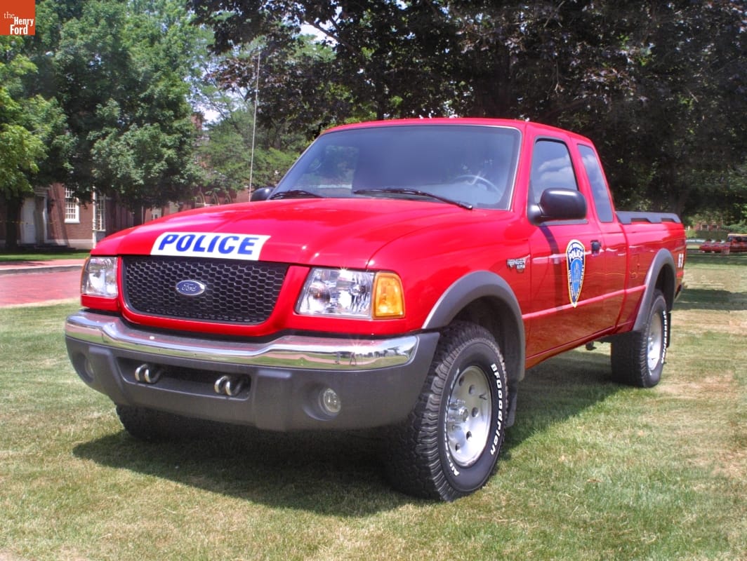 Red pick-up truck with badge on door and text 