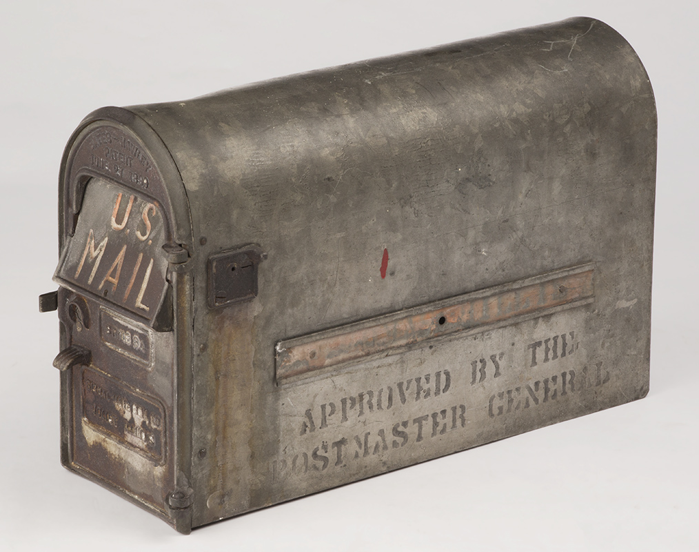 Silver arch-shaped mailbox with text on front and side