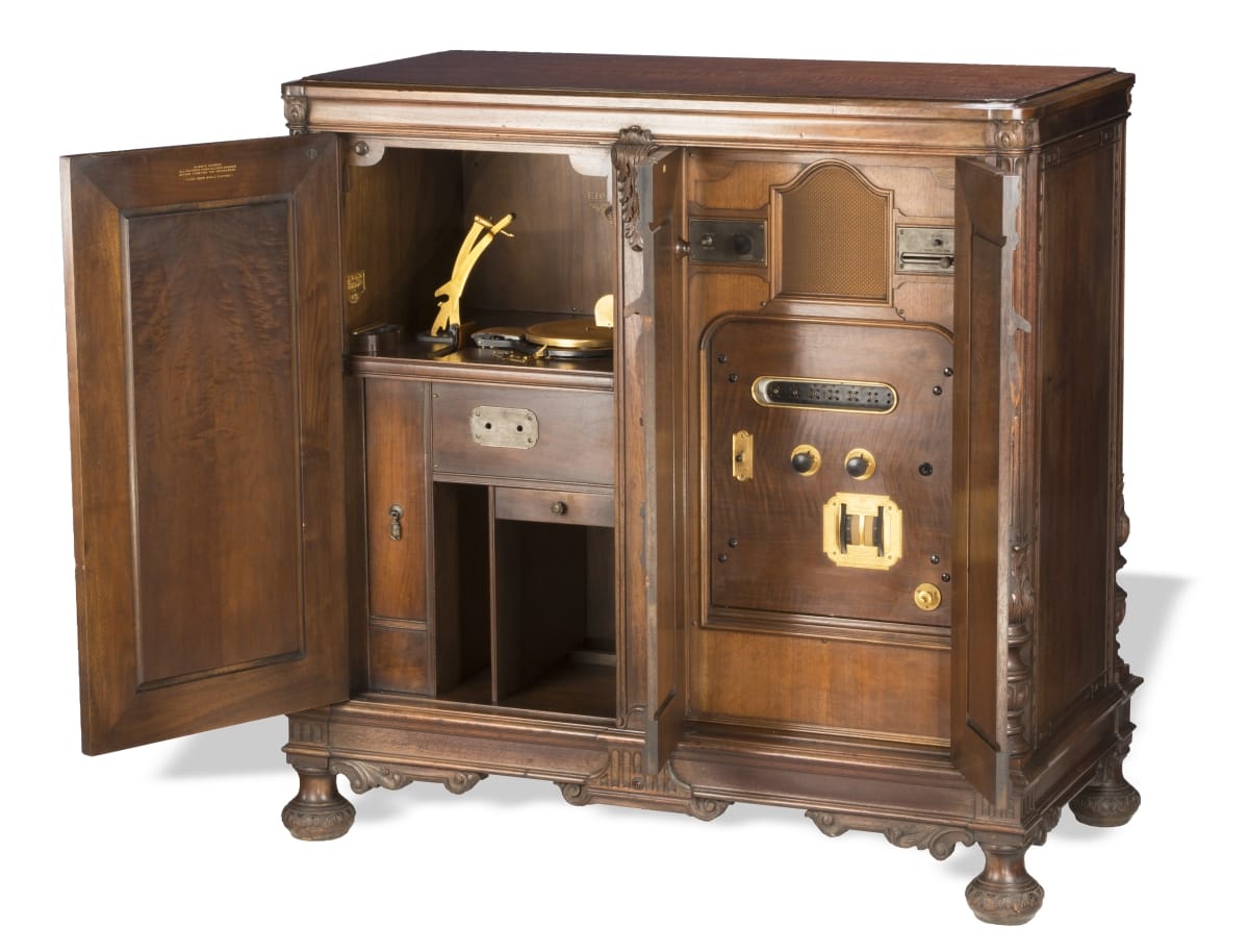 Wooden cabinet with knobs and machinery inside
