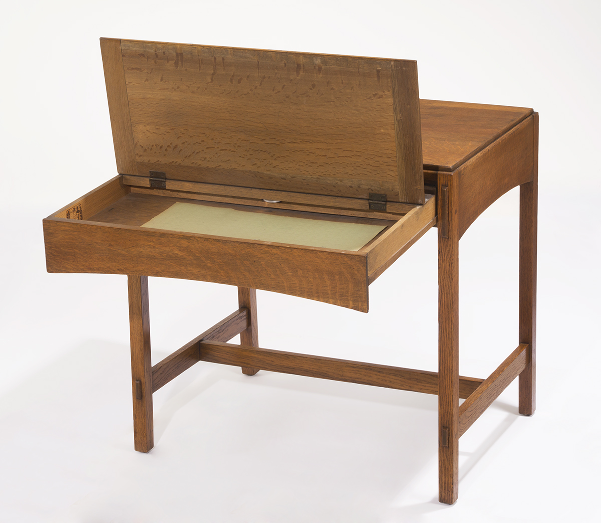 Wooden table with top extended and hinged open to reveal storage space inside