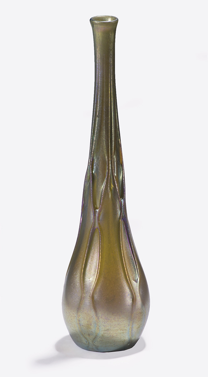 Tall, thin vase with organic shapes running down it, in shades of gold and brown