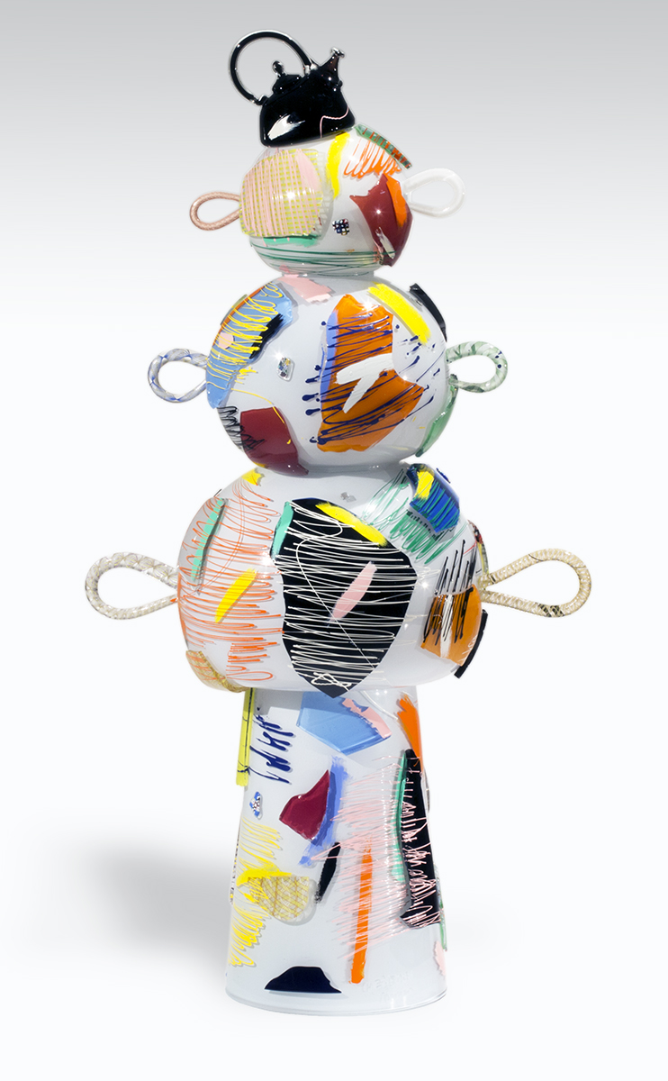 Multicolored artwork with a base topped by three progressively narrower spheres/ovals with a protruding loop on each side, with a teapot-shaped crown on top