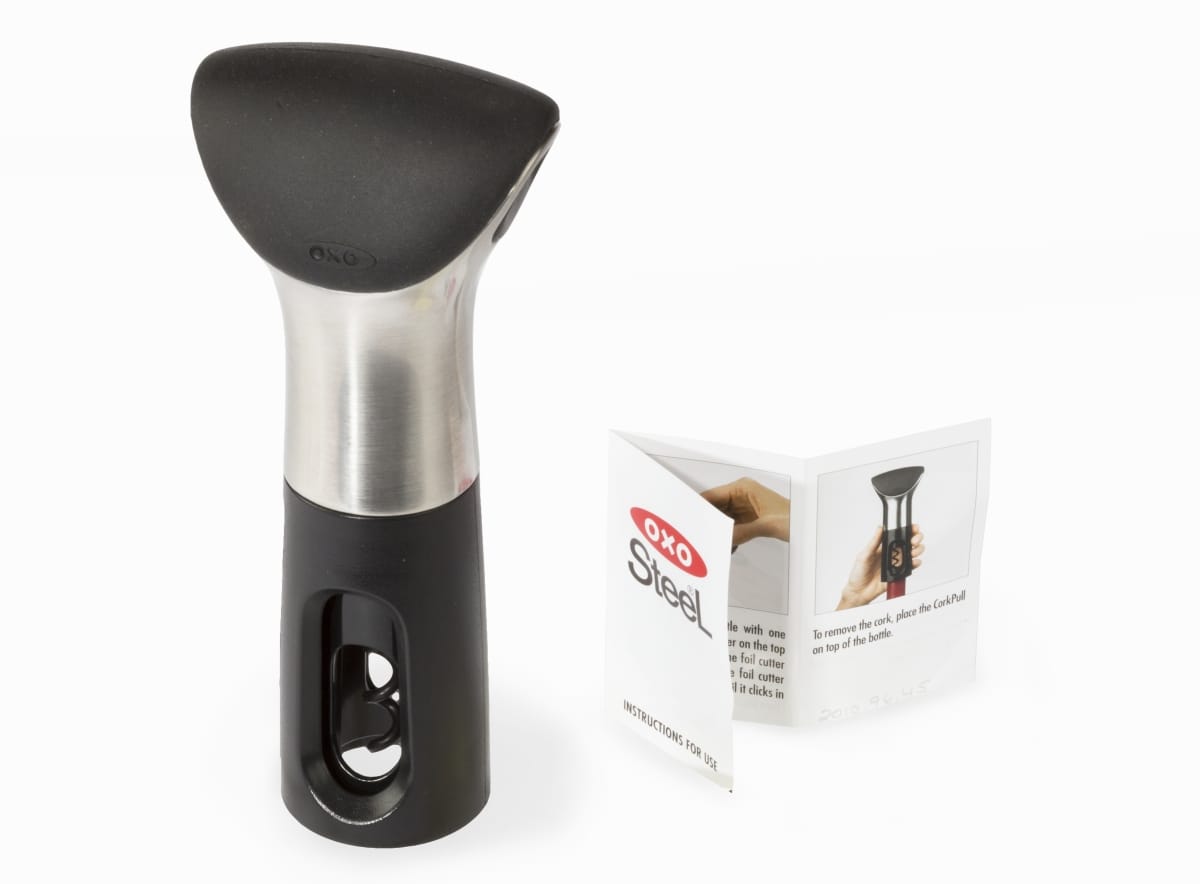Sleek black plastic and silver metal device with folded instruction sheet