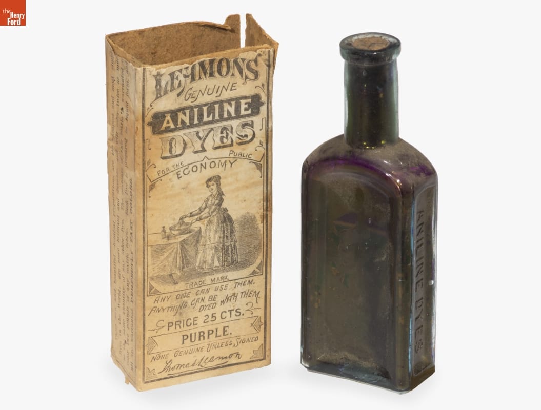 Wells, Richardson & Company Purple glass bottle sitting next to box with images and text