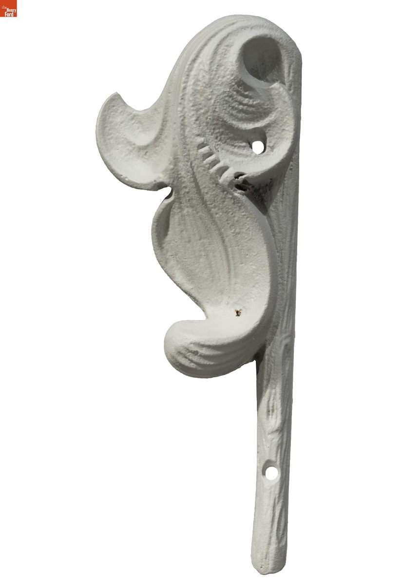 White architectural element in the shape of a curved leaf and stem