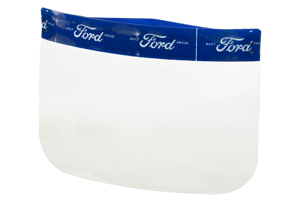 Face Shield, 2020 Clear plastic rectangle with rounded corners, topped with blue band patterned with white text
