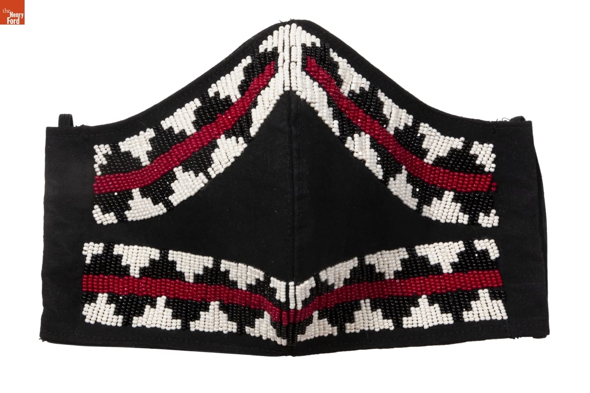 Beaded Face Mask, Made by Brighid Black face mask with red, white, and black geometric pattern in beads around edge