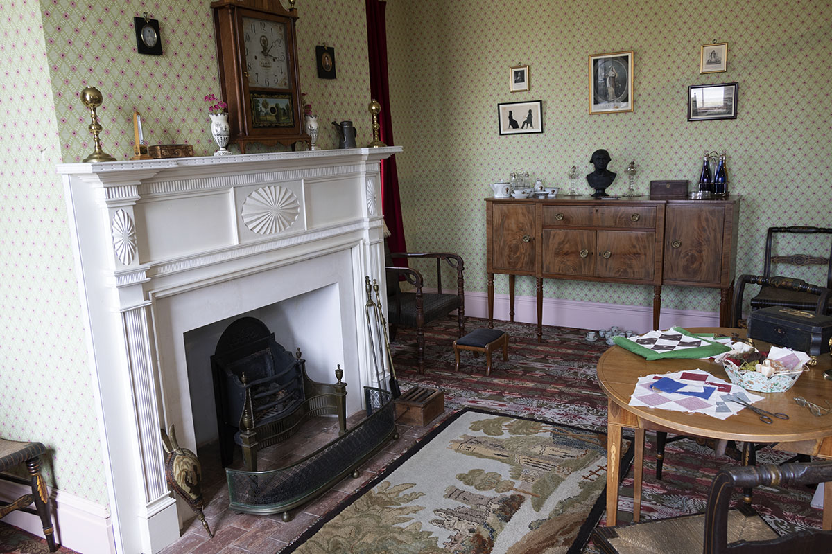 Room with large fireplace, table and chairs, and other furniture