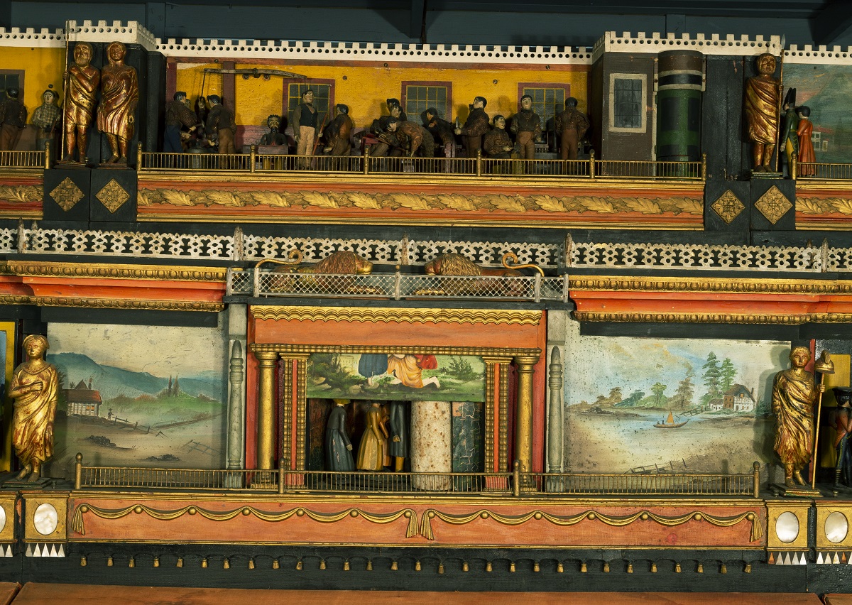 Wooden platform with two carved scenes with human figures, one above the other