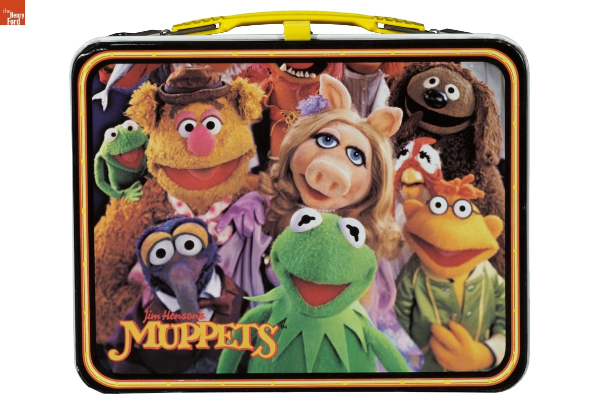 Lunchbox with images of Muppet characters, including Kermit the Frog, Miss Piggy, and others