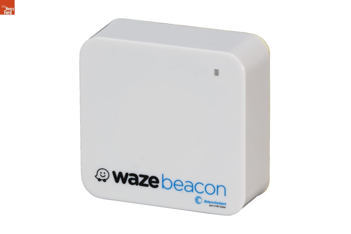 Square-shaped narrow white plastic box with text 