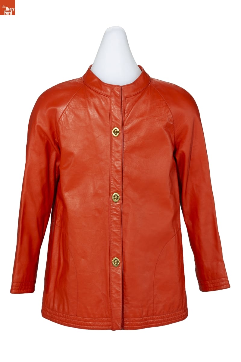 Burnt-orange leather jacket with Nehru collar, narrow long sleeves and three brass toggles down front