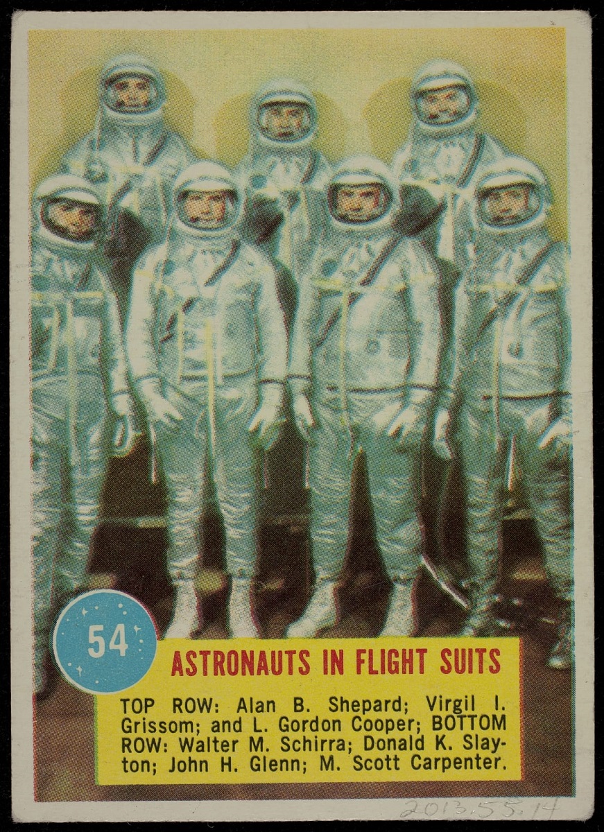 Trading card with image of seven people in silver suits; also contains text