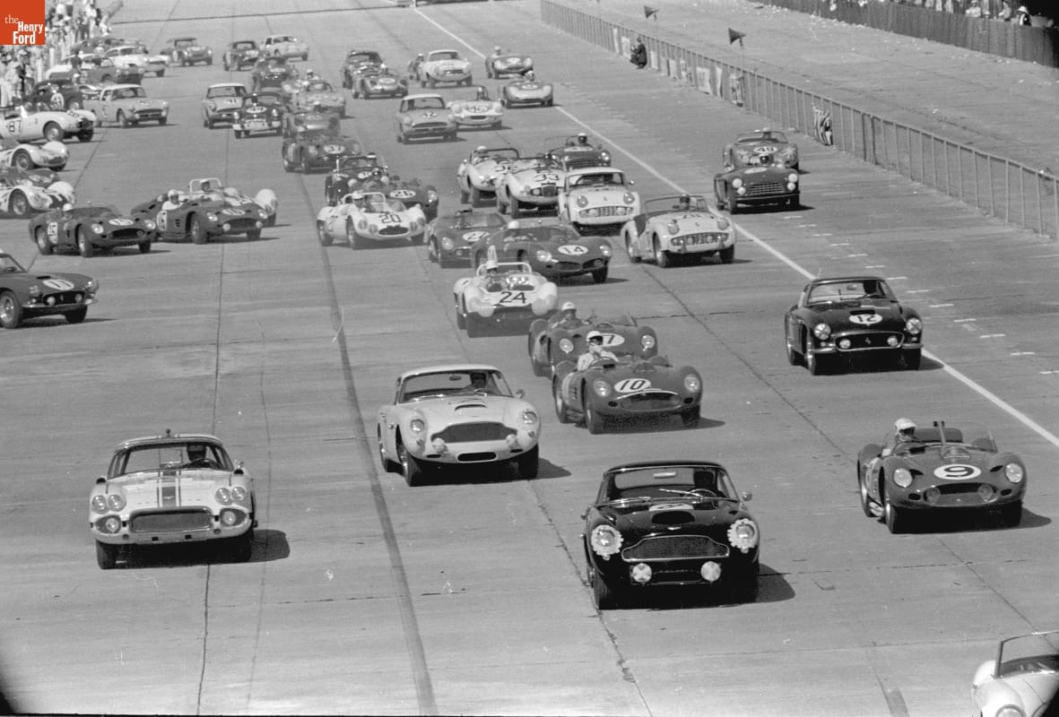 Many race cars drive on a track