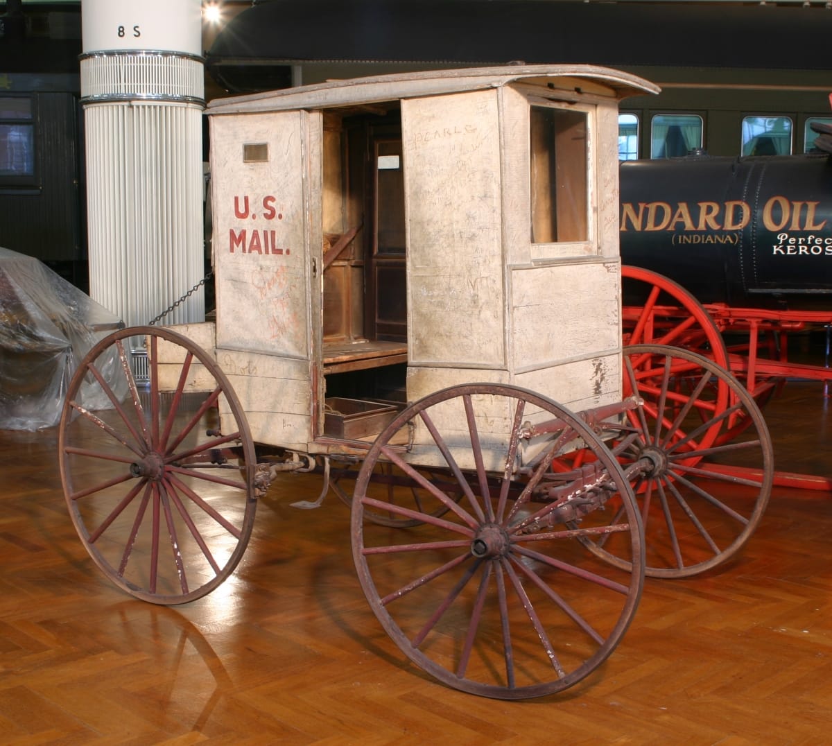 Small, boxy carriage with open doorway and text 