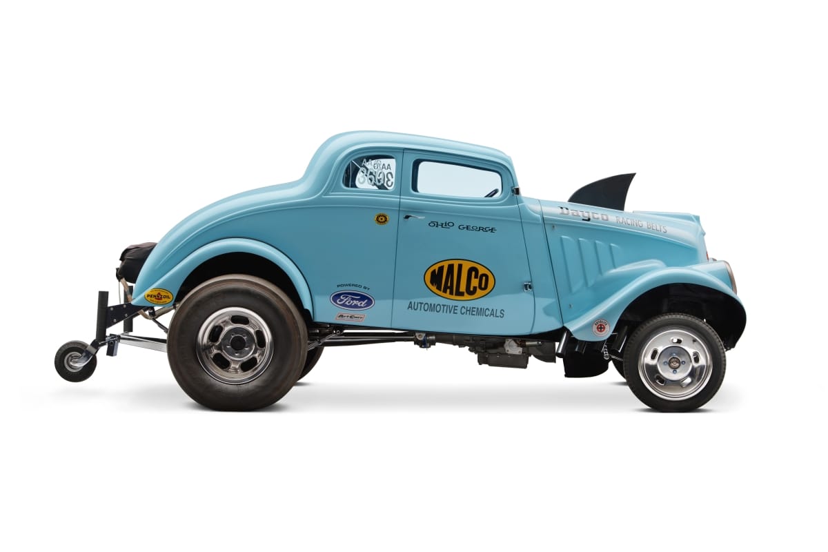 1933 Willys Drag Racer Baby blue race car with shark fin on hood, fifth wheel in back, and logos on side
