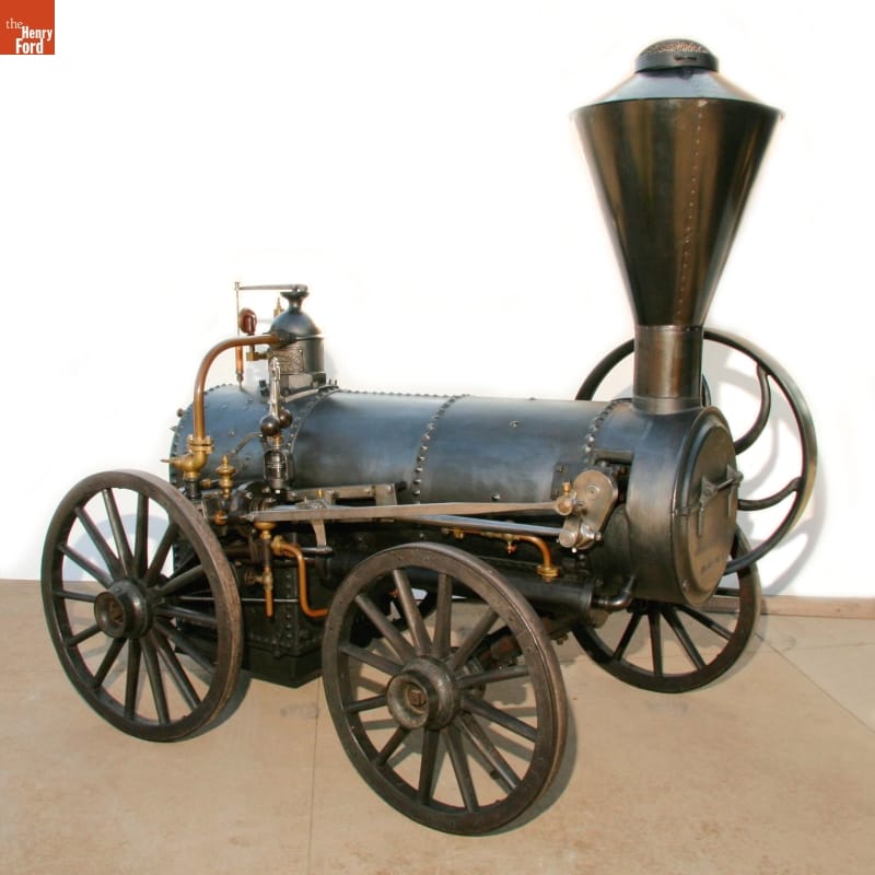 Portable Steam Engine, circa 1857 Horizontal cylindrical engine mounted on four wheels with a chimney or stovepipe at one end
