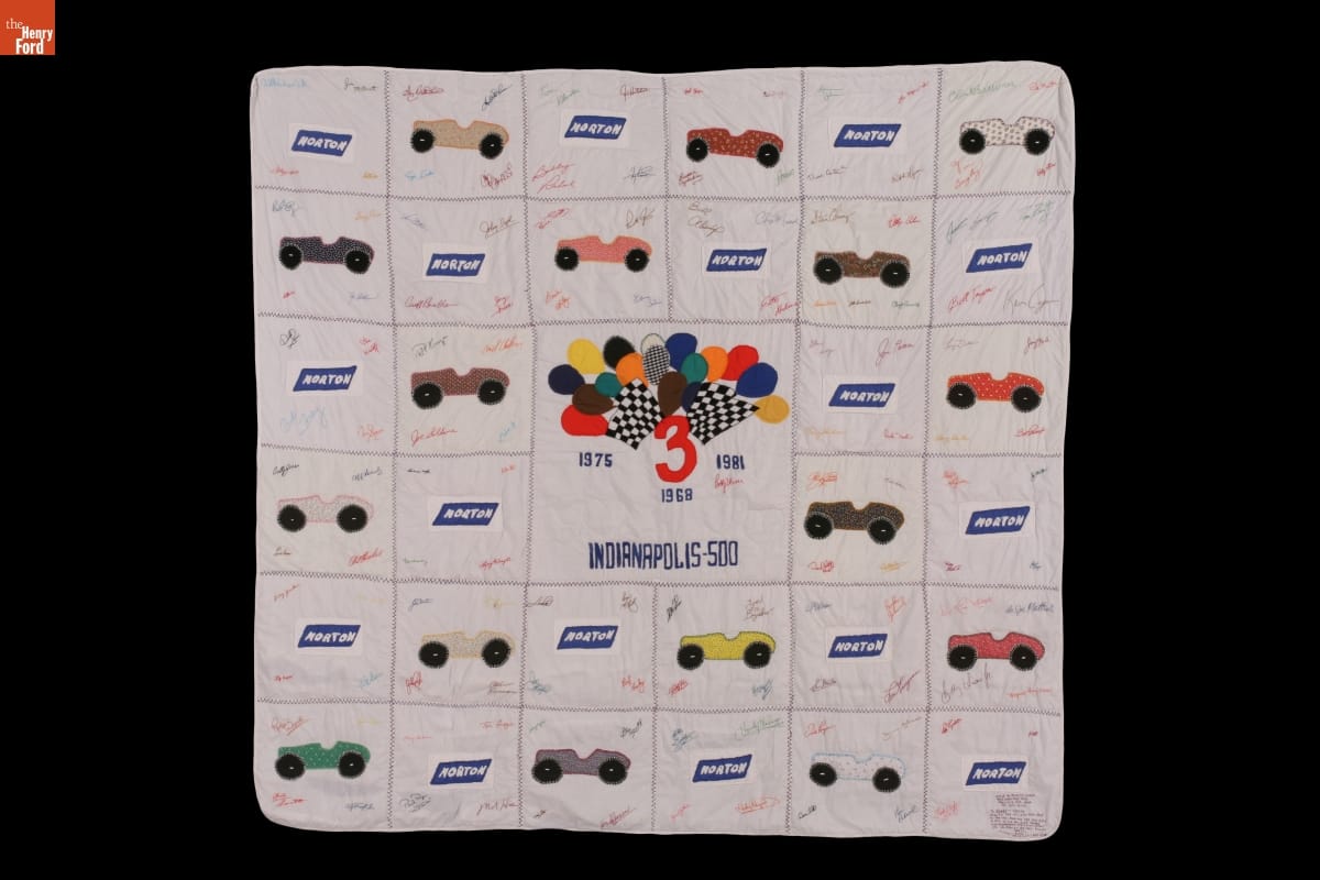 Quilt with blocks alternately featuring cars and logo for 
