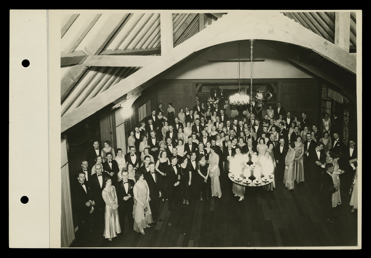 Aerial shot of group of people in suits and formal gowns in a ballroom