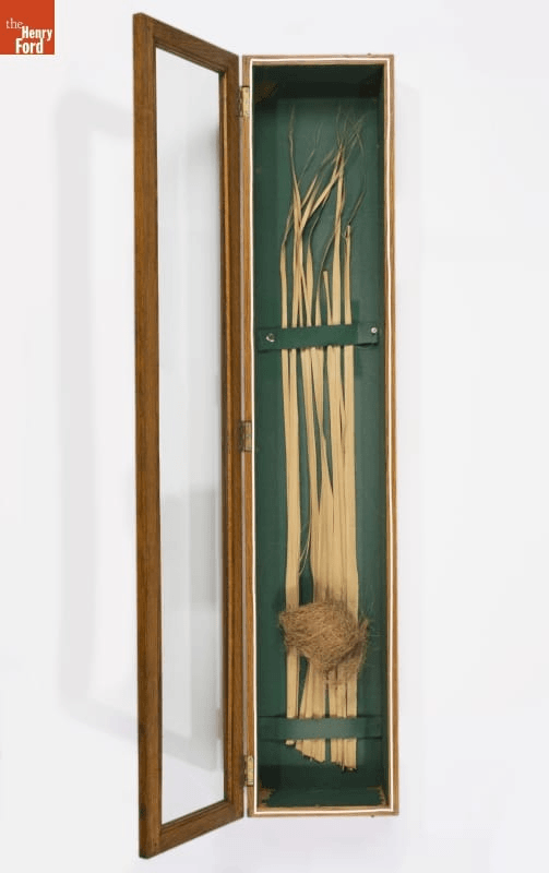 GIF cycling through three images: oriole's nest attached to reeds in display case; large, drill-shaped machine in room; and outline of bear created with yarn or string 